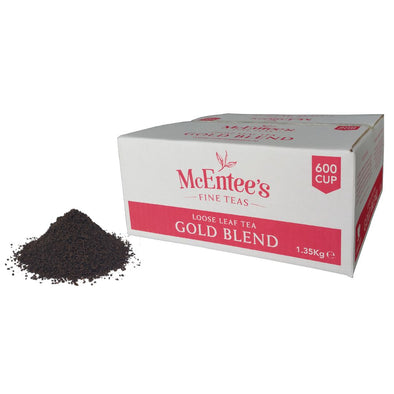 Box of McEntee's Gold Blend loose leaf tea with tea leaves on a white background
