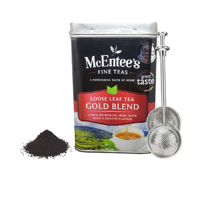 McEntee's Fine Teas Loose Leaf Tea Gold Blend can with tea powder and strainer on a white background