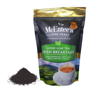 McEntee's Fine Teas Irish Breakfast loose leaf tea package with tea leaves on a white background