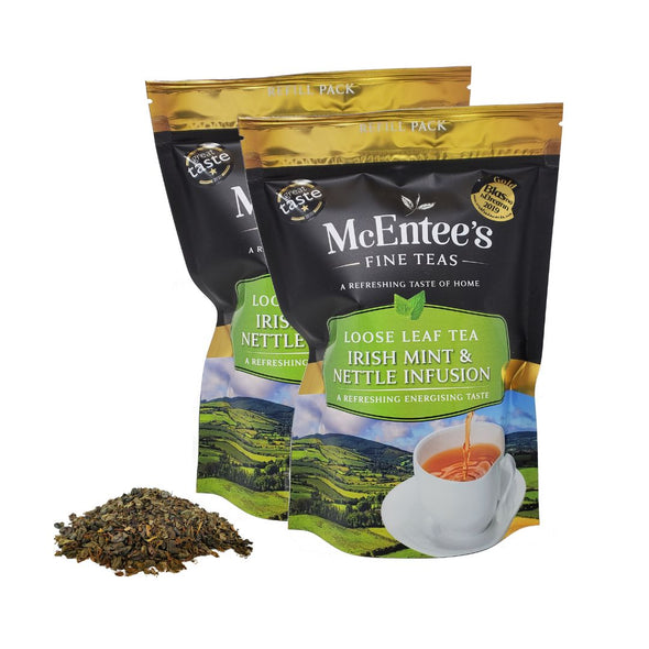 Two packages of McEntee's Fine Teas with loose tea leaves on a white background