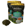 Two packages of McEntee's Organic Sencha Green Tea with loose tea leaves on a white background
